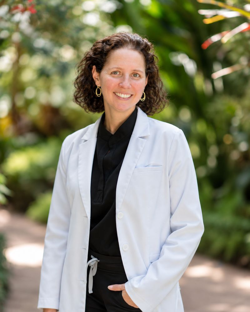 Dr. Bernice Teplitsky in a white coat, standing in a garden